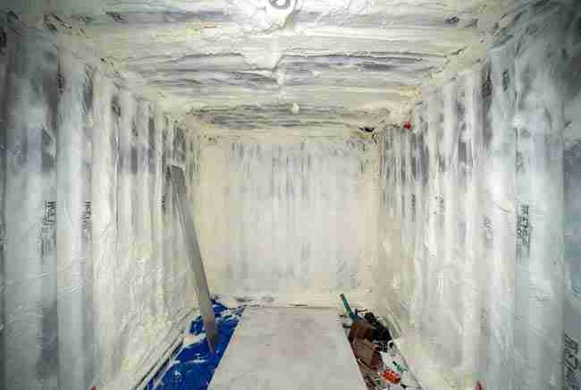 Interior of a shipping container cannabis grow room with professional spray foam insulation on walls and ceiling