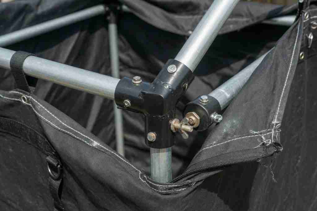 Close-up of grow tent frame corner connectors and steel poles