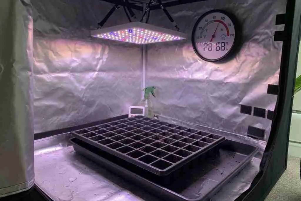Indoor grow tent with a climate meter ready for cannabis seedlings