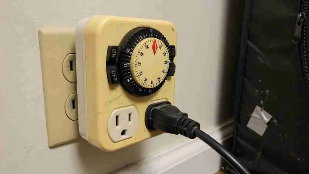 Mechanical outlet timer running a grow light on a schedule