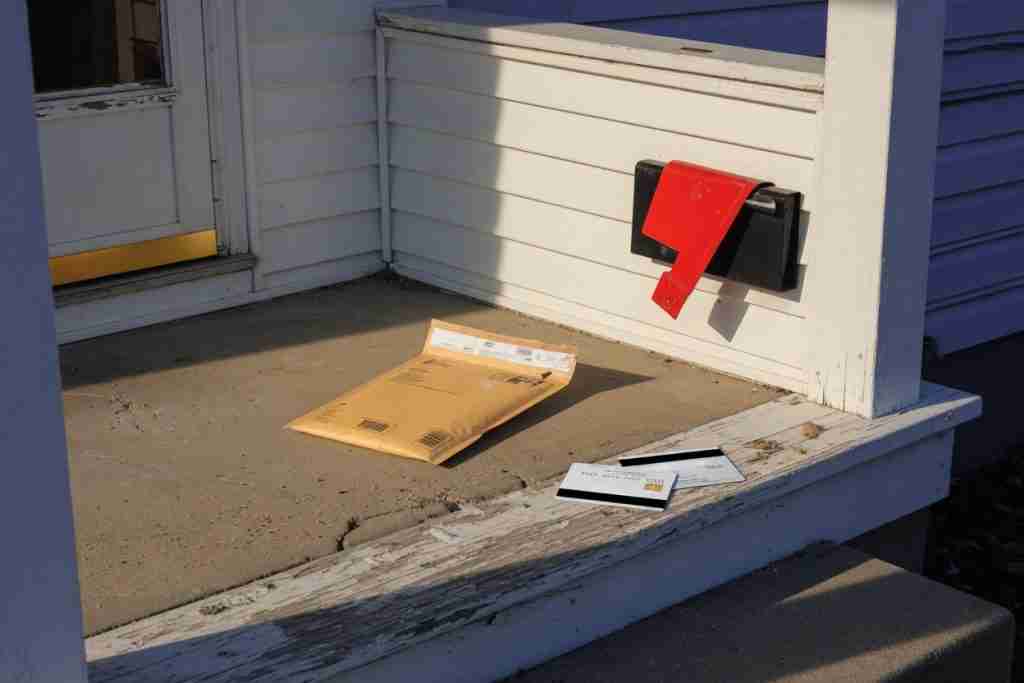 Discreet seed mailer on a United States porch with a raised mailbox flag and cards