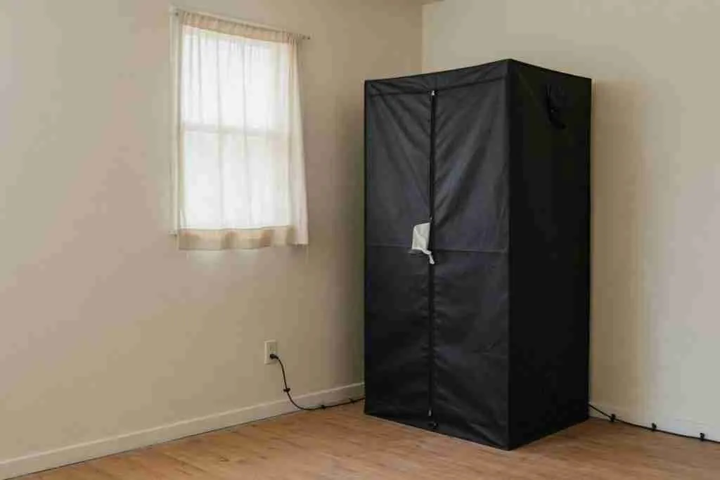 A closed grow tent in a spare room