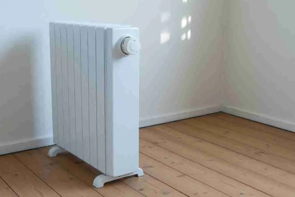 A plain oil-filled radiator in an empty room